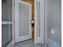 View of the home's front door with a decorative storm door and sidelights at 1675 Westminster Ct, The Villages, FL 32162