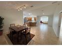 Bright, open-concept living space with a large kitchen island and lots of natural light at 17483 Se 74Th Netherclift Ter, The Villages, FL 32162