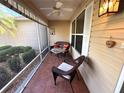Enclosed porch features tiled flooring, a ceiling fan, and cozy seating, perfect for relaxing at 17483 Se 74Th Netherclift Ter, The Villages, FL 32162