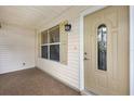 Inviting front entrance featuring a decorative glass door, neutral color palette, and charming details at 2017 Palo Alto Ave, The Villages, FL 32159