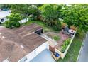 A landscaped backyard featuring a stone firepit, outdoor dining area, and partial privacy fence at 212 Blossom Ln, Winter Park, FL 32789