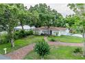 Charming single-story home with a brick pathway and beautiful lawn at 212 Blossom Ln, Winter Park, FL 32789