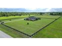 Aerial view of the property highlighting its vast green land and perimeter fence at 29222 Can Do Ln, Tavares, FL 32778