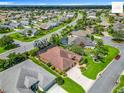 Aerial view showcases this home's prime location with nearby mature landscaping and pristine street at 2994 Adrienne Way, The Villages, FL 32163