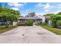 Inviting single-story home featuring a concrete driveway and a neatly landscaped front yard at 3015 Casselwood St, Winter Park, FL 32792