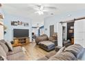 Spacious living room with hardwood floors, a ceiling fan, and comfortable seating at 3015 Casselwood St, Winter Park, FL 32792