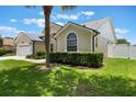 Well-maintained front yard showcasing green lawn, trimmed hedges, and a partial view of the home's facade at 3128 Ibis Hill St, Clermont, FL 34714