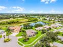 Aerial view of the neighborhood showcasing homes, ponds, and lush green spaces at 5620 Illumination Ln, Leesburg, FL 34748