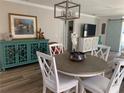 Inviting dining area with stylish light fixture, attractive decor, and wood-look flooring at 627 Nuevo Leon Ln, The Villages, FL 32159