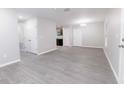 Spacious living room boasts modern gray vinyl flooring and ample natural light at 8161 Cr 647, Bushnell, FL 33513