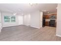 Open-concept living area with modern gray flooring flowing into the kitchen at 8161 Cr 647, Bushnell, FL 33513