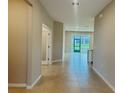 Inviting hallway with neutral colors and tile flooring leading to the open living area at 8949 Sw 76Th St, Ocala, FL 34481