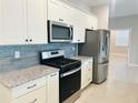 Well-equipped kitchen with granite countertops, stainless steel appliances, and subway tile backsplash at 8949 Sw 76Th St, Ocala, FL 34481