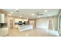 Open-concept living room and kitchen area with stainless steel appliances at 8949 Sw 76Th St, Ocala, FL 34481