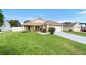 Charming single-story home with a well-maintained lawn, inviting curb appeal, and an attached two-car garage at 10431 Reagans Run Dr, Clermont, FL 34711