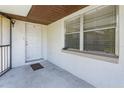 Inviting covered entrance featuring a freshly painted white door, a window, and a secure gated porch at 12 Windtree Ln # 202, Winter Garden, FL 34787