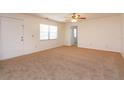 Neutral living room offering plush carpet, ceiling fan and access to multiple rooms at 12 Windtree Ln # 202, Winter Garden, FL 34787