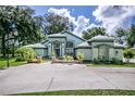 Beautiful single-story home with decorative accents, manicured landscaping, and a paved driveway at 168 Pond Rd, Mount Dora, FL 32757