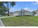 A cozy single-story home with an attached two-car garage and well-kept lawn and garden at 1808 Westpointe Cir, Orlando, FL 32835
