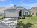 Inviting single-story home with a two-car garage and manicured front yard at 1808 Westpointe Cir, Orlando, FL 32835