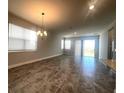 Open concept living room with tile floors, modern lighting, and sliding glass doors to the backyard at 2064 Asher Ave, Minneola, FL 34715