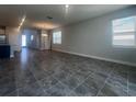 Spacious living room featuring tile flooring, recessed lighting, and large windows for natural light at 2064 Asher Ave, Minneola, FL 34715