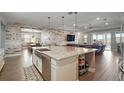 Spacious kitchen with granite island and stainless steel sink overlooking dining area and living room at 2136 Lula Rd, Minneola, FL 34715