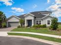 Charming one-story home with manicured front lawn, paver driveway, and an attached two-car garage at 2161 Cedar Springs Way, Minneola, FL 34715