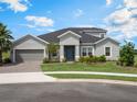 Charming one-story home with manicured front lawn, paver driveway, and an attached two-car garage at 2161 Cedar Springs Way, Minneola, FL 34715