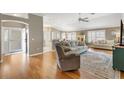 Spacious living room featuring hardwood floors, comfortable seating, and an abundance of natural light at 2465 Violet Ct, The Villages, FL 32162