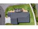 An overhead view of the backyard, showcasing the screen enclosed patio and surrounding landscaping at 4874 Noreen Ct, The Villages, FL 32163