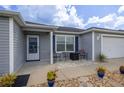 Cozy front porch with table and chairs, perfect for enjoying the outdoors at 516 Junction Pl, The Villages, FL 32163