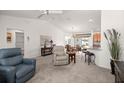Bright living room with lots of natural light, neutral carpet, and open layout at 516 Junction Pl, The Villages, FL 32163