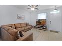 Comfortable living room with a large sectional sofa and natural light at 520 Rainbow Springs Loop, Groveland, FL 34736
