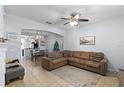 Open-concept living area with cozy sectional, dining space, and modern decor at 520 Rainbow Springs Loop, Groveland, FL 34736
