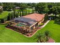 Aerial view of home highlighting the screened pool and verdant backyard at 5235 Greens Dr, Lady Lake, FL 32159