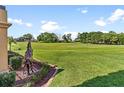 Spacious backyard view towards the golf course featuring a decorative horse statue at 5235 Greens Dr, Lady Lake, FL 32159
