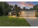 Charming home boasts a well-manicured lawn, inviting walkway, and attached two-car garage at 5460 Sw 103Rd Street Rd, Ocala, FL 34476