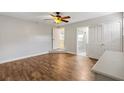Open main bedroom with hardwood floors leading to the ensuite bathroom and closets at 601 S 12Th St, Leesburg, FL 34748