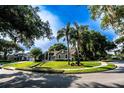 Beautifully landscaped corner lot with lush green grass and mature trees, showcasing the home's curb appeal at 681 Greywood Dr, Altamonte Springs, FL 32701