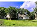 Lovely home with a well-manicured lawn and mature trees, providing shade and enhancing the property's beauty at 681 Greywood Dr, Altamonte Springs, FL 32701