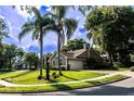 Well-maintained home on a corner lot, featuring mature palm trees and lush landscaping for a tropical feel at 681 Greywood Dr, Altamonte Springs, FL 32701