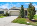 Welcoming home showcasing a manicured front yard and an attached two-car garage at 8128 Penrose Pl, Wildwood, FL 34785