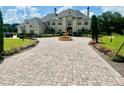 An impressive estate home with an expansive brick driveway and a majestic fountain at 10301 Savannah Ridge Ln, Winter Garden, FL 34787