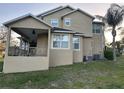 Back exterior view of home featuring a covered porch and grassy area at 1096 Linkside Ct, Apopka, FL 32712