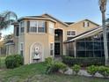 Stunning two-story home featuring a water fountain, lush landscaping and a beautiful walkway to the front door at 1096 Linkside Ct, Apopka, FL 32712