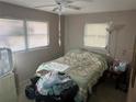 Simple bedroom with two windows, neutral walls, and space for a queen-size bed at 11651 Fairmont Ave, Leesburg, FL 34788