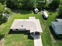 An aerial view of a home showcasing a large backyard with storage and ample space at 11681 Se 72Nd Court Rd, Belleview, FL 34420
