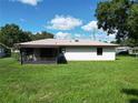 Spacious backyard featuring a screened porch, perfect for outdoor relaxation and entertaining at 11681 Se 72Nd Court Rd, Belleview, FL 34420