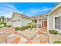 Inviting covered front porch with seating area and decorative stone landscaping at 1401 Madrigal Ln, Lady Lake, FL 32159